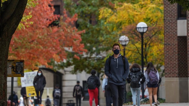 University of Michigan students walk around campus in Ann Arbor on Tuesday, Oct. 20, after Washtenaw County Health Department issued a Stay in Place order for undergrad students because of the rising number of COVID-19 cases on campus.