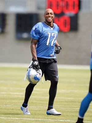 Lions wide receiver Andre Caldwell jogs onto the field for start of practice Wednesday.