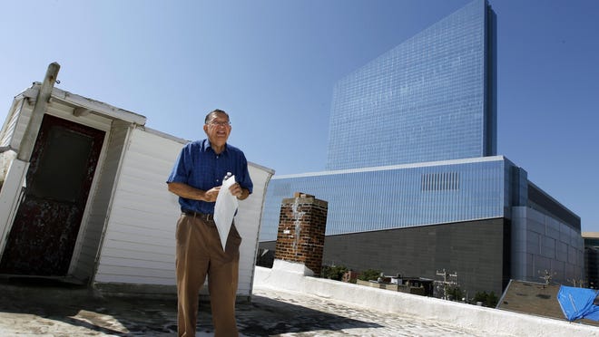 FILE - In this Wednesday, Aug. 27, 2014 file photo, Charlie Birnbaum, 68, stands on the roof of his home near the now closed Revel Casino Hotel in Atlantic City, N.J. The Casino Reinvestment Development Authority tried to take the home where Birnbaum's parents lived and where his mother was killed, even though the casino closed. On Wednesday, Aug. 19, 2015, Superior Court Judge Julio Mendez ruled that Birnbaum can stay in the home unless the Casino Reinvestment Development Authority present more evidence that a redevelopment plan will be implemented. (AP Photo/Mel Evans,file)