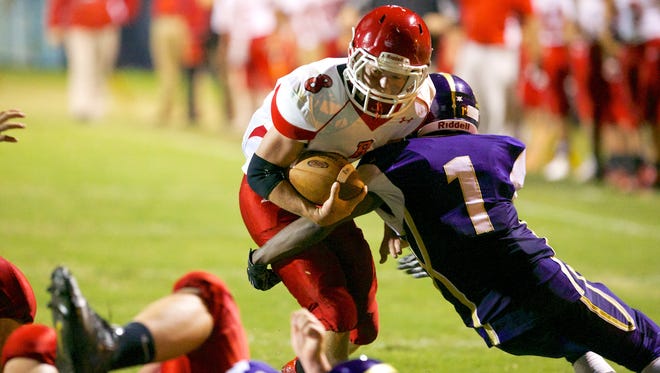 Riverheads' Ben Agnor looks for the end zone  as Waynesboro's Michael Brown closes in for the tackle during Friday night's matchup at Waynesboro High School.