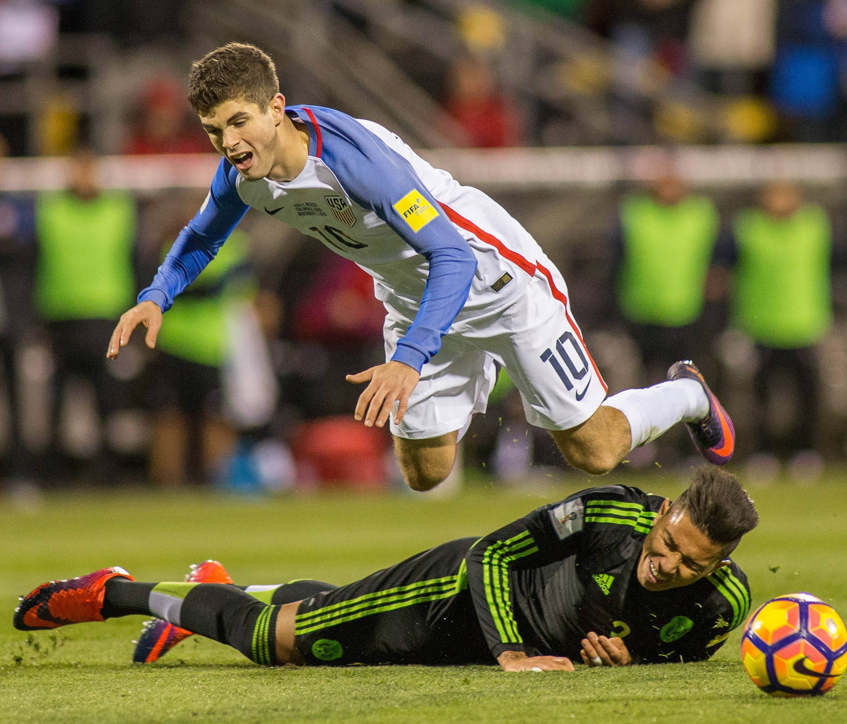 Christian Pulisic is fouled by Mexico defender Carlos Salcedo during a match in 2016.