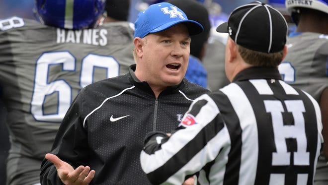 UK head coach Mark Stoops talks with an official during the University of Kentucky football game against University of Louisville at Commonwealth Stadium in Lexington, Ky., on Saturday, November 28, 2015.