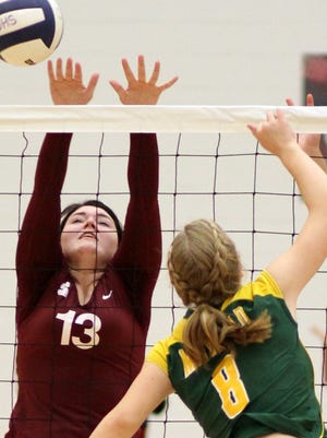 Junior Lady Cat Nicole Wycoff (13) reaches for the block against Mayfield hitter  Kinnley Davis during Tuesday three-set loss to the visiting Trojans.