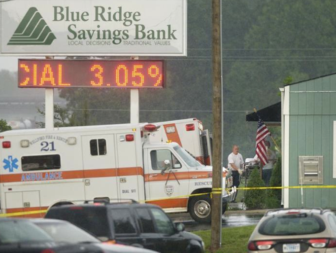 EMS workers bring a stretcher into the Blue Ridge Savings
