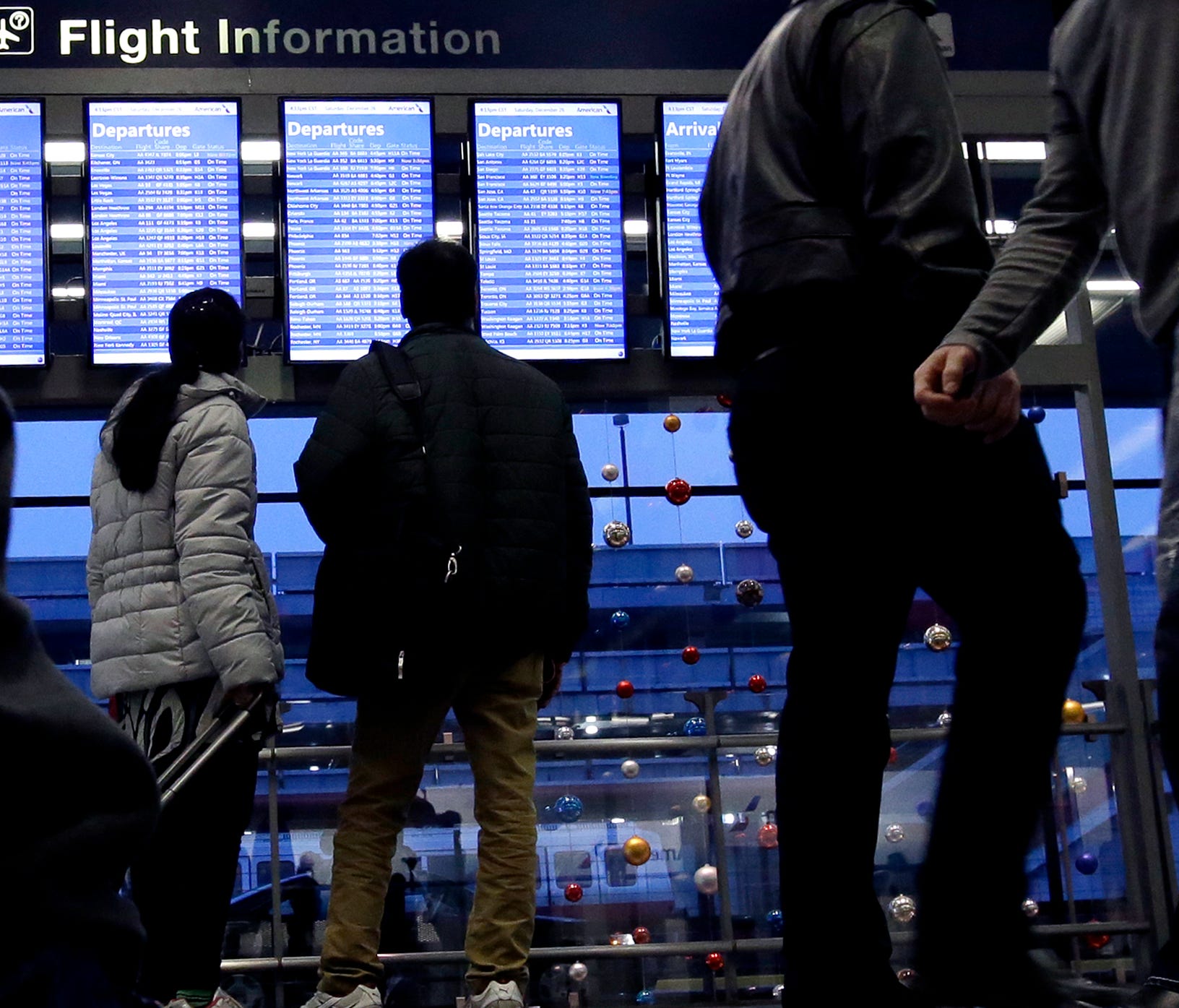Travelers walk to their gates at Chicago's O'Hare International Airport on Dec. 26, 2015.