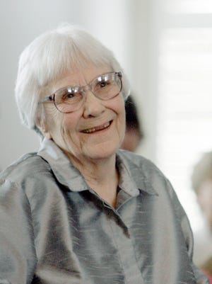 Harper Lee, author of the Pulitzer Prize-winning novel, "To kill a Mockingbird," smiles during a ceremony honoring the four new members of the Alabama Academy of Honor at the Capitol in Montgomery, Ala. Publisher Harper announced Tuesday that "Go Set a Watchman," a novel Lee completed in the 1950s and put aside, will be released July 14. It will be her second published book.