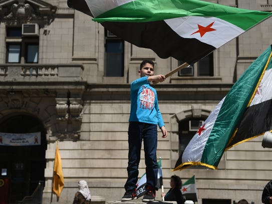 Walid Alkabouni, 9, of Elmwood Park proudly waves a
