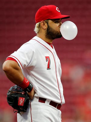 Cincinnati Reds third baseman Eugenio Suarez (7) blows a bubble at third base in the top of the second inning of the MLB National League game between the Cincinnati Reds and the Miami Marlins at Great American Ball Park in downtown Cincinnati on Friday, May 4, 2018.