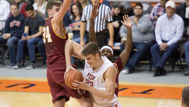UTEP center Hooper Vint (23) muscles his way under the basket in the first half.
