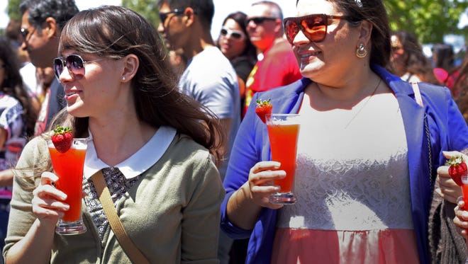 Jennifer Meyers, left, and Janelle Gonzalez, co-workers from Children’s Hospital in Los Angeles, try strawberry beer at the 2015 Strawberry Festival in Oxnard.  This year's event will take place May 19 and 20.