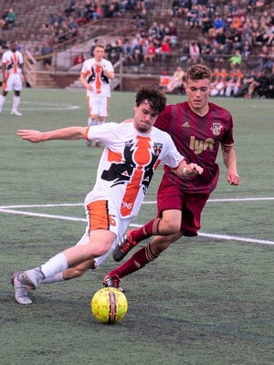 The Michigan Bucks' Marcelo Borges (left) takes on a Detroit City FC defender in the US Open Cup.