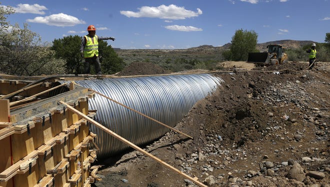 Rudy Shorty, a construction worker with Aztec Well Servicing, works on a culvert on May 23 at the Bloomfield Irrigation Ditch in Blanco.