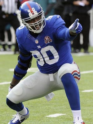 In this Sunday, Dec. 28, 2014, file photo, New York Giants' Jason Pierre-Paul (90) reacts after sacking Philadelphia Eagles' Mark Sanchez during the first half of an NFL football game in East Rutherford, N.J. The Giants have no firsthand knowledge about the extent of the hand injuries Pro Bowl defensive end Pierre-Paul sustained in a July 4, 2015, fireworks accident in Florida. Team co-owner John Mara disclosed that most of the Giants' knowledge about JPP's condition has come from his agents and through text messages with the 26-year-old, who was tagged as a franchise player and due to make at least $14.8 million this season.