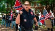 A member of the Ku Klux Klan shouts at counter protesters