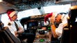 Pilots aboard a UPS Boeing 747 don Santa hats as they