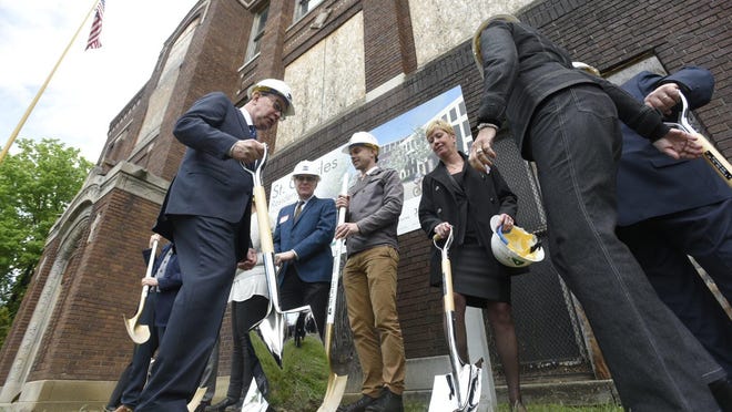 Participants take their places in a ceremonial ground breaking for renovation to the historic St. Charles school in Detroit on Monday.