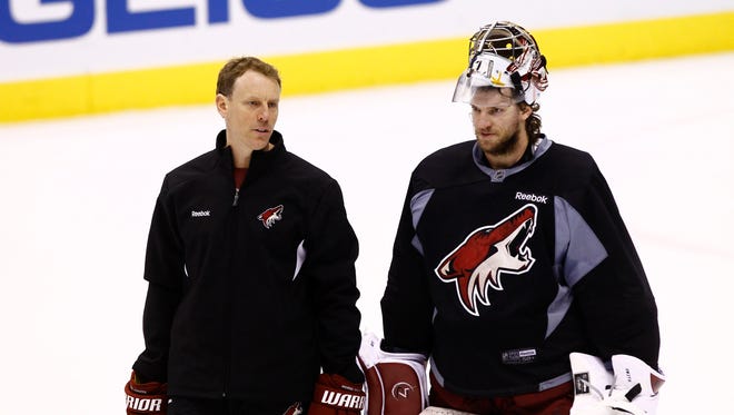 Phoenix Coyotes goal tending coach Sean Burke talks to goalie Mike Smith during practice in May 2012 as they prepare to play the L.A. Kings in the Western Conference finals at Jobing.com Arena in Glendale, AZ.