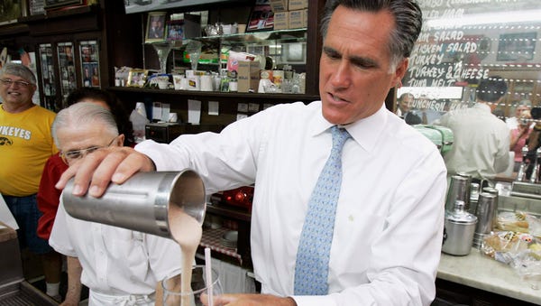 Mitt Romney pours a milkshake during a visit to th