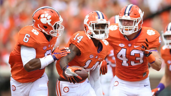 Clemson Denzel Johnson (14) celebrates with linebackers Dorian O'Daniel (6) and linebacker Chad Smith (43) after recovering a fumble by S.C. State wide receiver Ahmaad Harris (1) in the end zone for a touchdown during the first quarter on Sept. 17, 2016 at Clemson's Memorial Stadium.