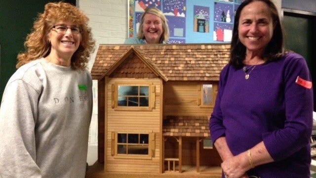 Carol Berg (left) and Jane Polan are in front of the beautiful doll house donated to the Birmingham Education Foundation Garage Sale while Sally Zeitvogel is in back of the dollhouse. Berg and Polan were in charge of the sale while Zeitvogel was a lead volunteer. They have worked together to raise funds for the BEF for years.