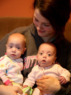 Kylee Bowling, 17, holds her four-month-old twins Abrina, left, and Ariel at their Felicity home Monday November 28, 2016. The twins were born at 31 weeks and had to remained in the NICU for a couple of weeks. Kylee is finishing her senior year in high school. Kylee's Wish List request is; Double stroller, bedroom furniture for the girls, clothes and toys for twins, money for driver's education, laptop, gas cards.