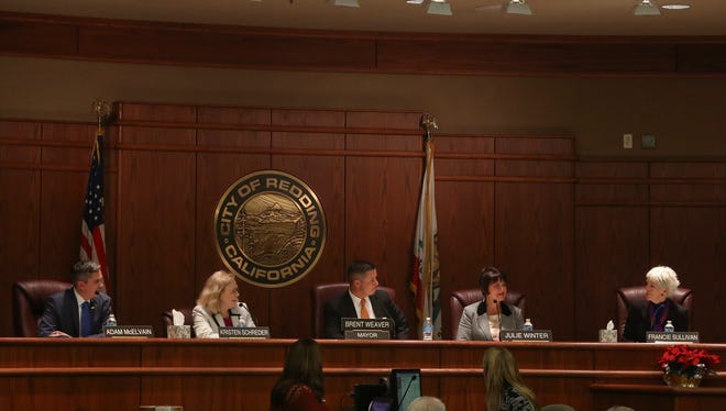 Adam McElvain (left) and Julie Winter (second from right) take their seats Tuesday on the Redding City Council.