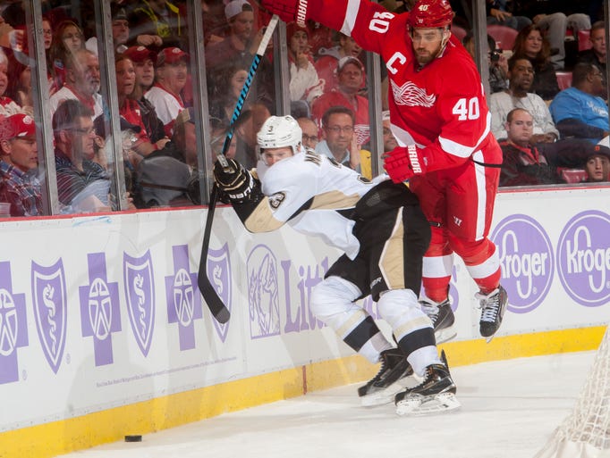 Red Wings left wing Henrik Zetterberg leaps over Penguins