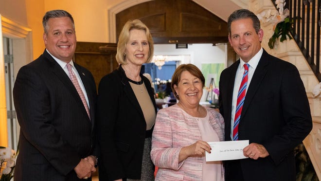 From left are Rich Gieseler, regional president of M&T Bank Florida
; Diane McNeal, senior private banker of Wilmington Trust; 
 Beth Walton, chief executive officer of the Town of Palm Beach United Way
; and Ted Brown, regional president Wilmington Trust, Florida, pose with a donation to the United Way at the Wilmington Trust reception.