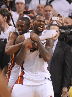 LeBron James (6) celebrates with Dwyane Wade (3) after