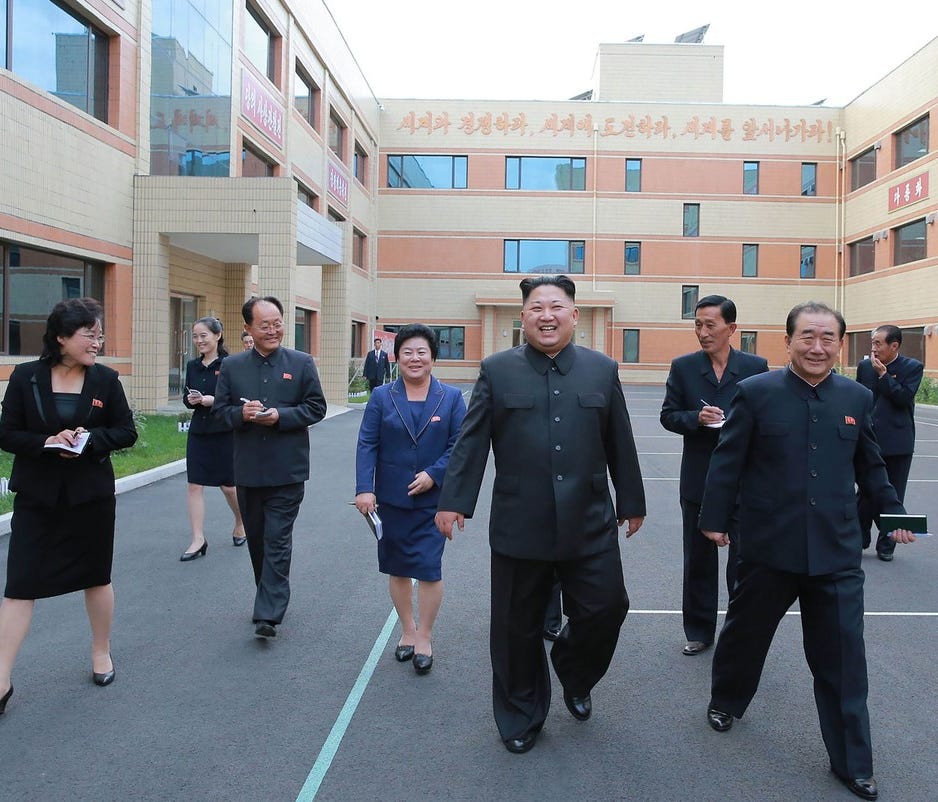 This undated picture released from North Korea's official Korean Central News Agency (KCNA) on October 19, 2017 shows North Korean leader Kim Jong Un, center, visiting the Ryuwon Footwear Factory in Pyongyang.