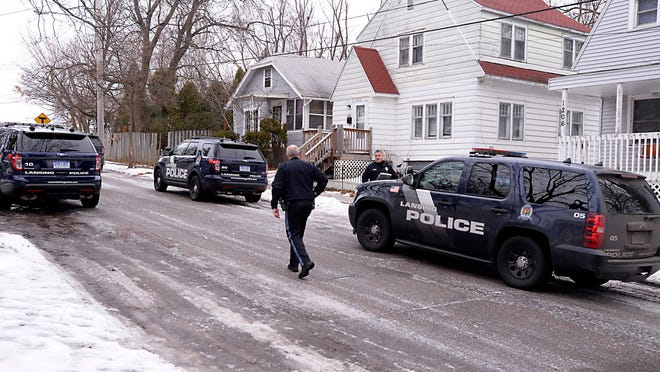 Lansing police officers secure the scene after three officers were injured during an altercation with several home invasion suspects on Glenn Street on the city’s north side Monday morning.