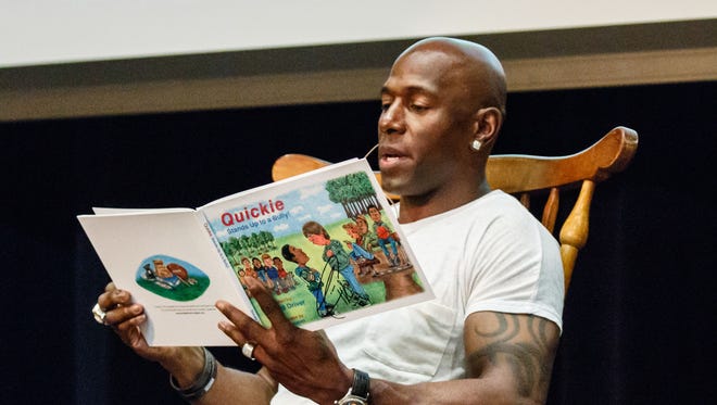 Super Bowl Champion, Donald Driver, reads his children’s book to Pewaukee Lake Elementary School students during an assembly at Pewaukee High School on Monday, May 21, 2018. The students won a visit from the former Green Bay Packers wide receiver by donating 65,909 items to Goodwill during the Pack'er Up Donation Challenge in April.