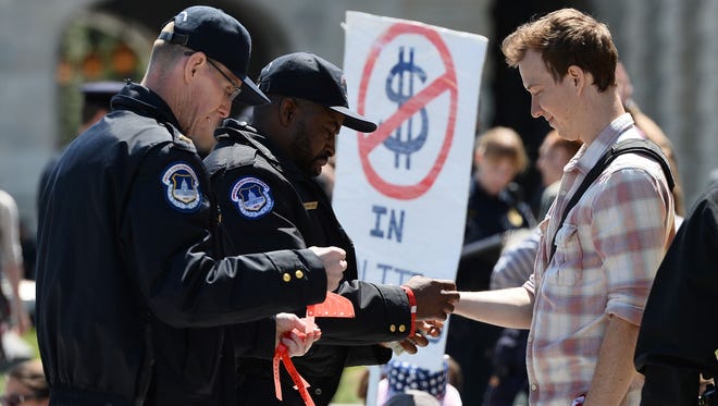 Protesters are processed for arrest by police during a Democracy Spring demonstration on Capitol Hill  in Washington, DC on April 13, 2016, calling to change voting laws and campaign finance.