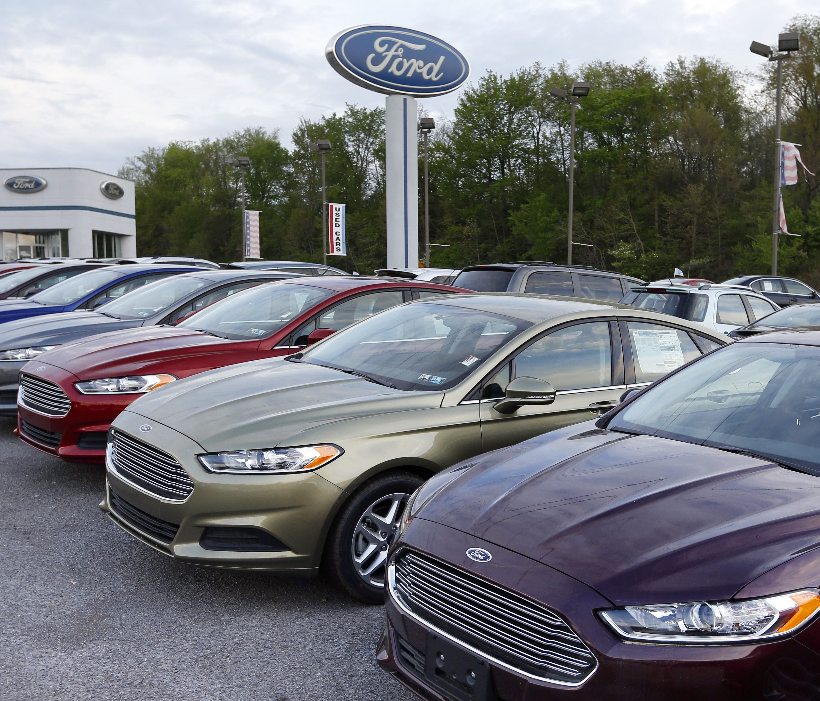 Cars are seen at an automobile dealer in Zelienople, Pa.