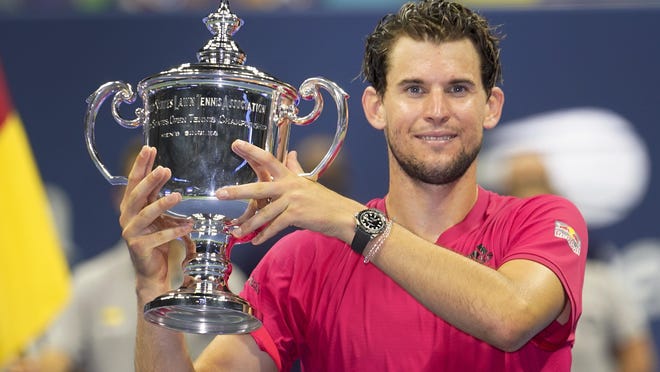 Dominic Thiem, of Austria, holds up the championship trophy after defeating Alexander Zverev, of Germany, in the men's singles final of the U.S. Open on Sunday.