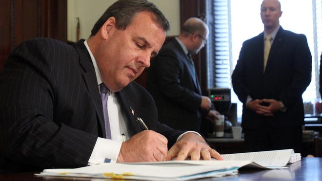 Gov. Chris Christie enacts the 2016 state budget but uses his line-item veto to delete around $1.6 billion in spending.