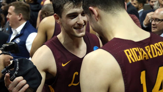 Loyola-Chicago guards Clayton Custer, left, and Ben Richardson celebrate after defeating Kansas State in the Elite Eight of the NCAA tournament at Philips Arena in Atlanta.