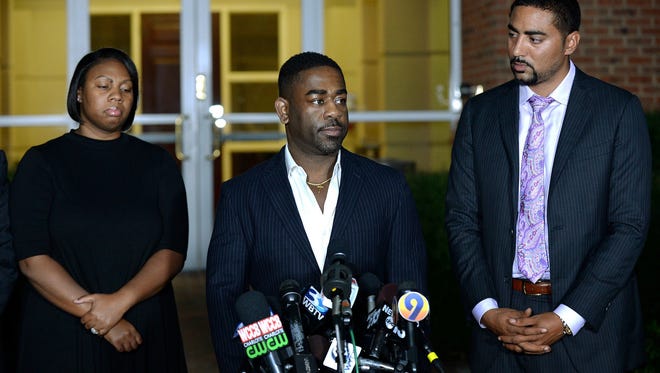 Rachel, left, and Ray Dotch, center, sister-in-law and brother-in-law to Keith Lamont Scott, give a news conference in Charlotte, N.C., on Saturday, Sept. 24, 2016. At right is the family's attorney, Justin Bamberg. Scott was fatally shot by a Charlotte-Mecklenburg police officer on Tuesday.