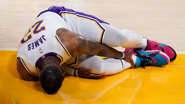 Los Angeles Lakers forward LeBron James holds his 