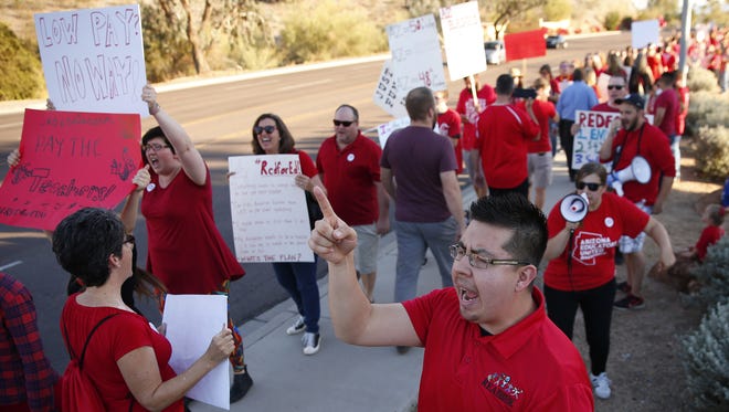 Teachers and supporters protest outside the KTAR studios where Gov. Doug Ducey was a guest in Phoenix, Ariz. March 12, 2018. Teachers are pushing for higher wages.