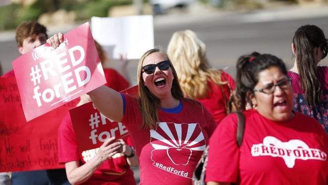 Teachers call for Gov. Ducey to act on their demand for pay increases outside the KTAR studios in Phoenix on April 10, 2018.
