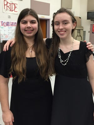 South Salem High School senior Kaitlyn Clawson, left, and Sprague senior Elizabeth Soper pose for a picture at the Salem-Keizer School District's all-city band concert in February at North Salem High School. Clawson and Soper are recipients of Oregon Music Hall of Fame's music-education scholarships.