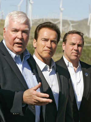 From left, Fred Noble of Wintec Energy, California governor Arnold Schwarzenegger, and Palm Springs Mayor Steve Pougnet speak to the media about green energy on a Wintec windmill farm on March 2, 2010.
