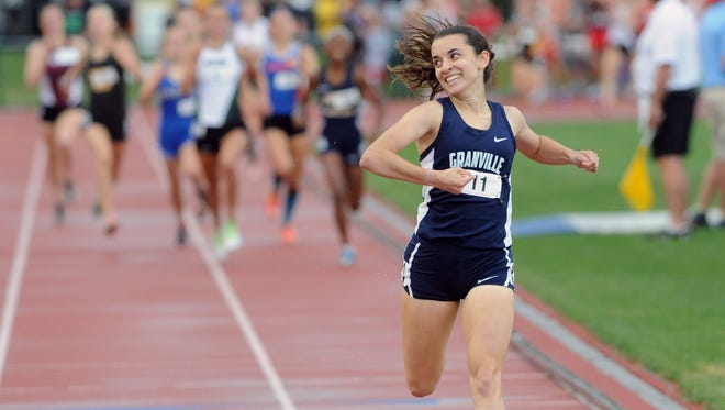 Granville's Micaela DeGenero pumps her fist while smiling toward the crowd after winning the 1,600 meter run during the Division I state final Saturday at Jesse Owens Memorial Stadium in Columbus.