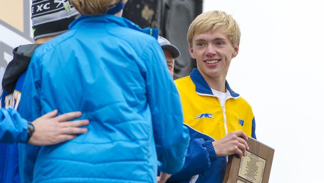 Carmel senior Ben Veatch is awarded the Charles F. Maas Mental Attitude Award during the IHSAA Cross-Country State Championship in Terre Haute, Ind., Oct. 31, 2015.