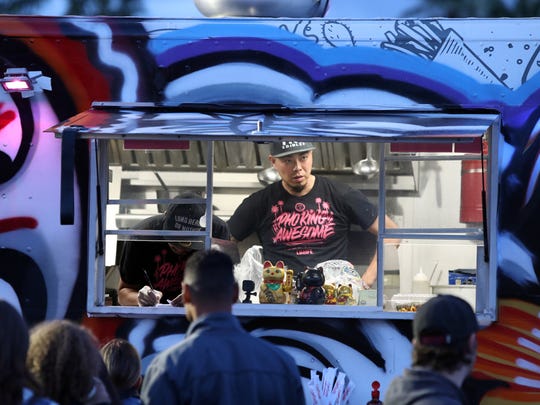 People stand in line at Pho King during the Food Truck