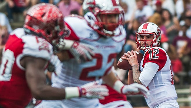 Western Kentucky Hilltoppers quarterback Brandon Doughty (12) looks for an open receiver during an NCAA college football game against Miami of Ohio, Saturday, Sept. 26, 2015, in Bowling Green, Ky.