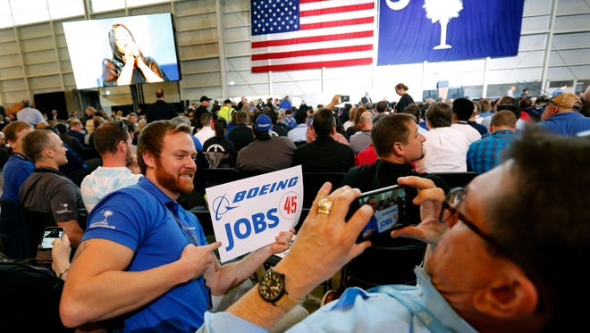 Patrick Brothers, left, smiles for the camera as Wendell Bailey, takes his photo as the two Boeing employees wait with others for President Donald Trump to speak, Friday, Feb. 17, 2017, in the final assembly building at Boeing South Carolina in North Charleston, S.C.