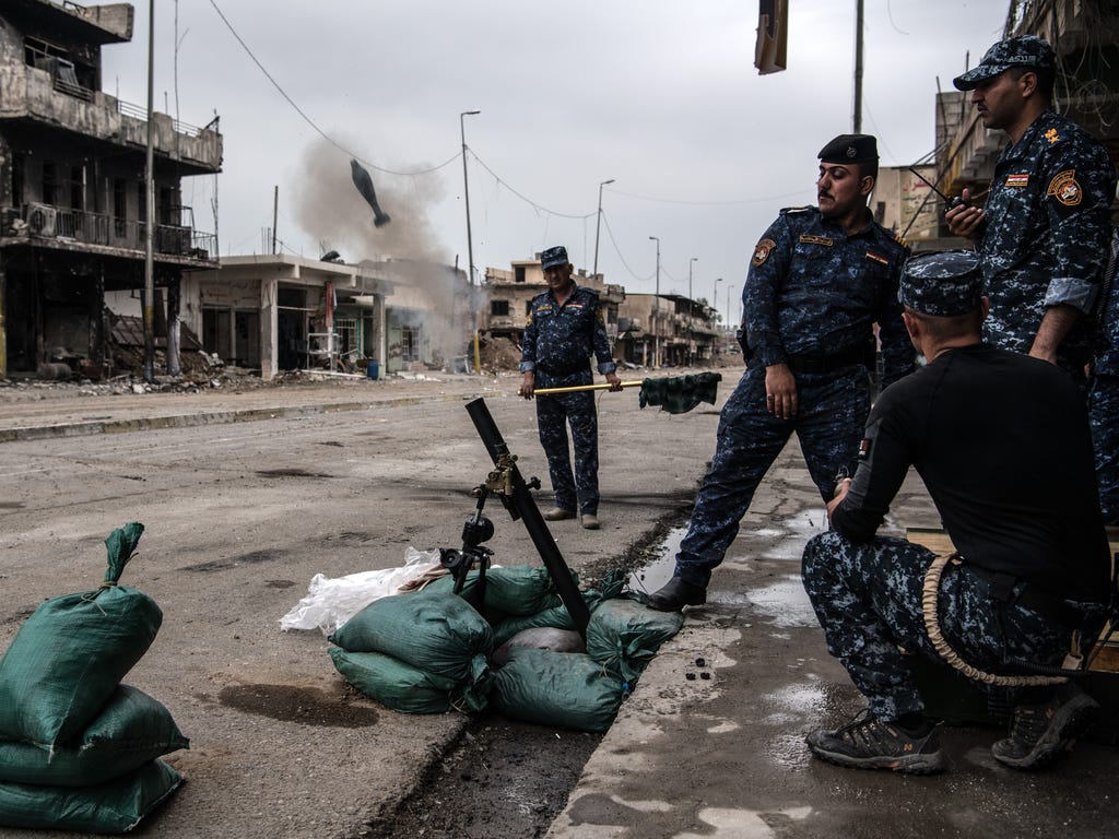 Iraqi federal police fire a mortar at an Islamic State position during the battle to recapture west Mosul in Mosul, Iraq. Despite being completely surrounded, Islamic State fighters are continuing to put up stiff resistance to Iraqi forces who are no