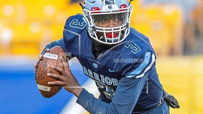 In this Nov. 16, 2019 photo, Central Valley's Ameer Dudley looks to pass during the WPIAL Class 3A championship at Heinz Field in Pittsburgh. Ameer, 17, is a junior at Central Valley High School and one of the most sought-after quarterback recruits in the area. He treats every game of “Madden NFL” or “NBA 2K” just as seriously as he does playing in a WPIAL championship game at Heinz Field — as long as he’s competing against friends. (Steph Chambers/Pittsburgh Post-Gazette via AP)
